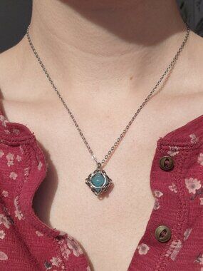Aquamarine blue caged pearl necklace with a small silver chain